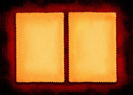two pieces of yellowed paper on red textile backgroundの写真素材