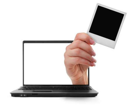 notebook with a hand sticking out of itの写真素材