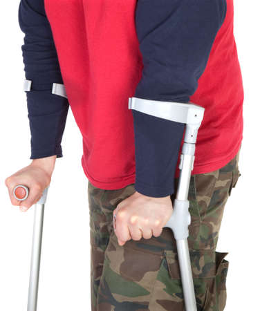 man walking with a crutch against white backgroundの写真素材