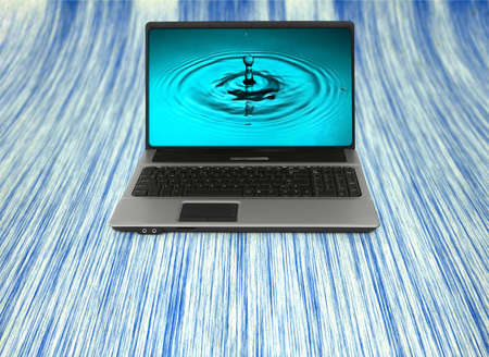 Notebook with water splash wallpaper, photo inside is my propertyの写真素材