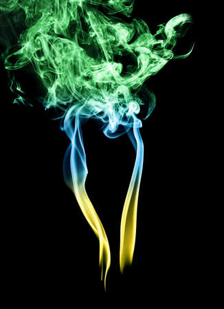 smoke formation in three colors on black backgroundの写真素材