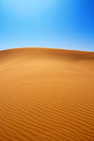 sand dunes and cloudless blue skyの写真素材