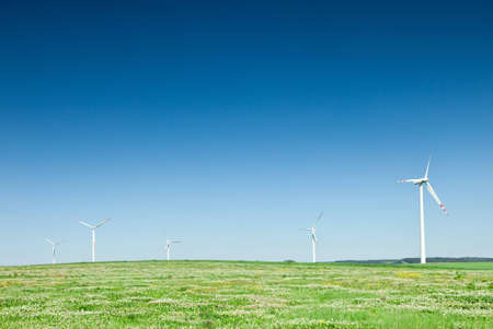group of wind turbines on green fieldの写真素材