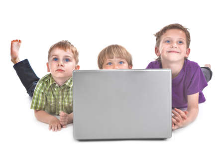 studio shot of three kids with laptop の写真素材