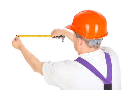 manual worker with tape measure over white background.の写真素材