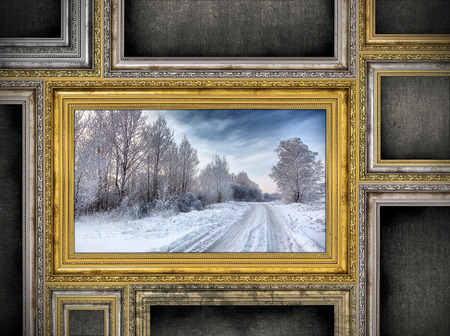 golden wooden frame with beautiful landscape among other empty frames. Photo inside frame is my property.の写真素材