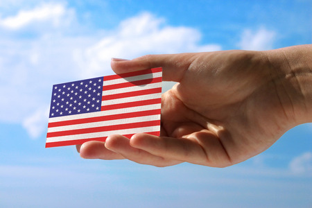 hand holding small flag of  USAの写真素材