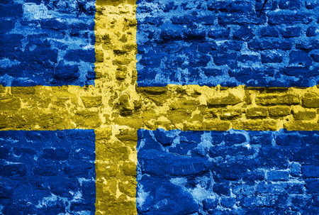 Swedish flag over old brick wallの写真素材