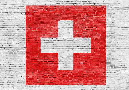 Flag of Switzerland over white brick wallの写真素材