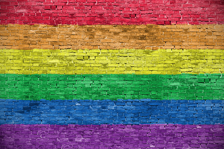 Rainbow flag over old brick wallの写真素材