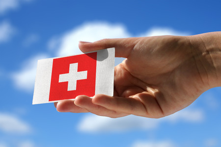 National flag of Switzerland over small visiting cardの写真素材