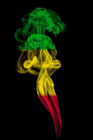 Smoke pillar colored in flag of reggae musicの写真素材
