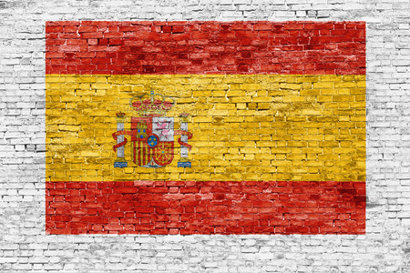 Spanish flag painted on white brick wallの写真素材