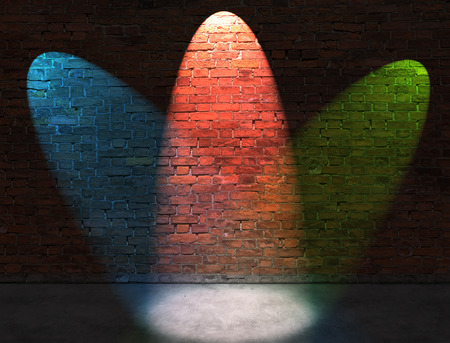Three RGB spot lights on old brick wallの写真素材