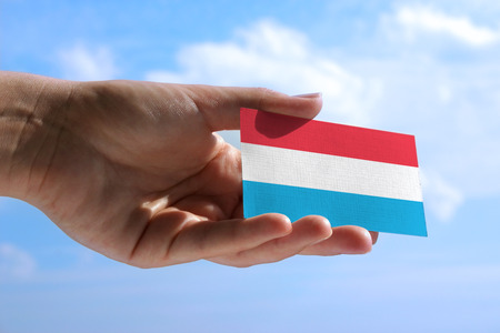 Small flag of Luxembourg, cumulus clouds in backgroundの写真素材