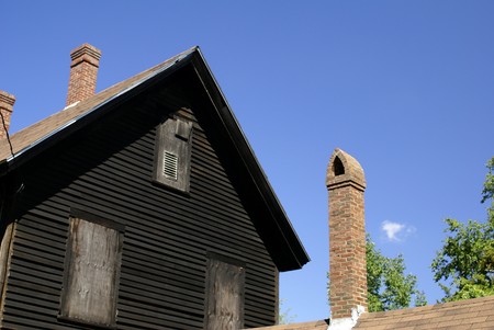 an old house and chimneys against the skyの写真素材