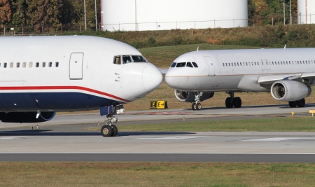 Charlotte, North Carolina - October 21, 2012: Two commercial jets sit on a runway at...