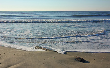 Early morning on a deserted ocean beachの写真素材