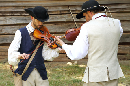 MCCONNELLS, SC - July 11, 2015:  Violinists in colonial costumes perform during the American Revolutionary War recreation of the Battle of Huck's Defeat at Historic Brattonsville.  The Patriot victory was originally fought nearby on July 12, 1780.のeditorial素材