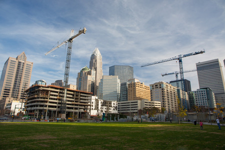 CHARLOTTE, NC - December 12, 2015: The skyline of downtown Charlotte, North Carolina, as seen from Romare Bearden Park, with multiple construction cranes.のeditorial素材