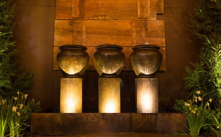 Three dramatically lit pottery fountains.の写真素材