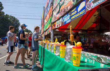 MATTHEWS, NC - September 4, 2017: People line up to purchase food and drinks from a vendor at the 25th annual "Matthews Alive" street festival.のeditorial素材