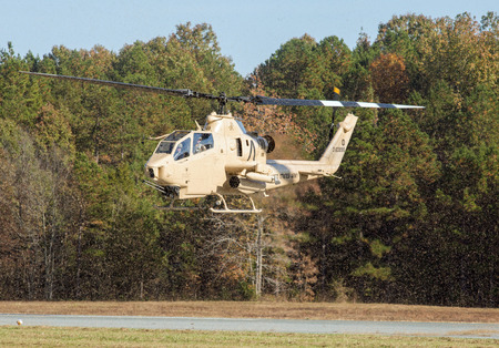 MONROE, NC - NOVEMBER 11, 2017:  An AH-1F Cobra attack helicopter performing at the Warbirds Over Monroe Air Show in Monroe, NC.のeditorial素材