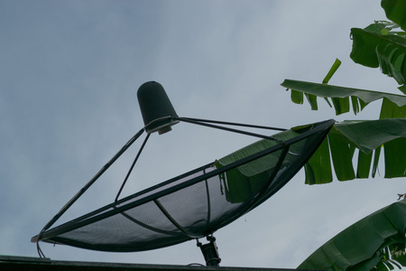 The satellite dish and sunset sky.