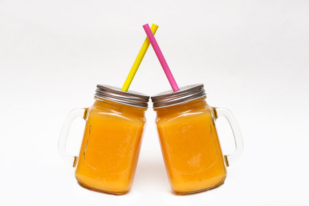 Two glasses with natural orange juice isolate on a white background. Healthy citrus drink with copy spaceの写真素材