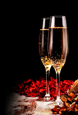 two glasses of champagne and christmas decorations over grunge woodの写真素材
