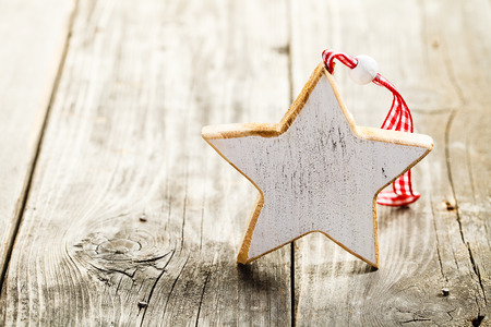Christmas star made of wood with rope standing on wooden backgroundの写真素材