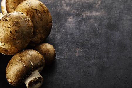 brown champignons on old rustic background
