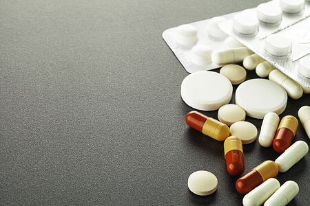 A lot of colorful medication and pills  lying on the tableの写真素材