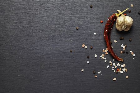 Different spices on textured background with place for copy