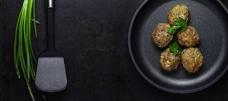 top view on cutlets on pan and spatula on board over old rustic backgroundの写真素材