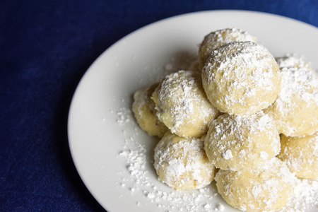 Holiday Russian Tea Cake cookies ready to eat on a white serving plateの写真素材
