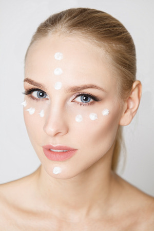 women with moisturizing cream on the face. Perfect skin.Careの写真素材