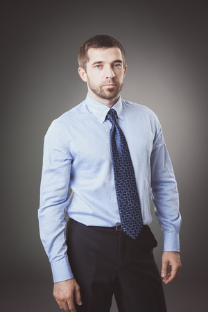 Portrait of businessman with beard in suit. Studio. Grey backgroundの写真素材