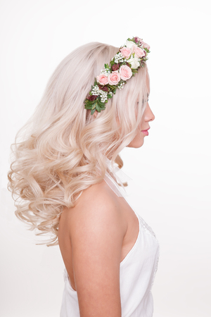 women blonde curly hairstyle with flowers isolated on whiteの写真素材