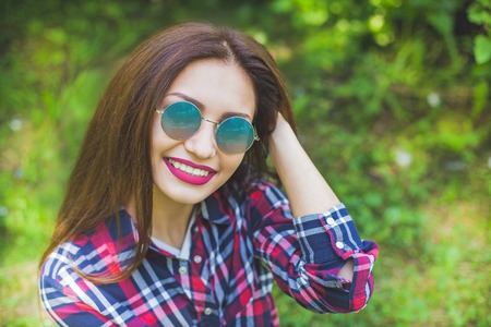 Portrait of beautiful smiling women in blue sunglasses. Summer. White teethの写真素材