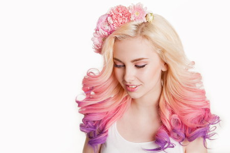 Youth women with colored hair smiling. Flowers in her hair. Studio, isolated, white background. Concept spring, summer. look down. Gradientの写真素材