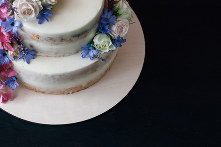 Cake with flowers decor on black table