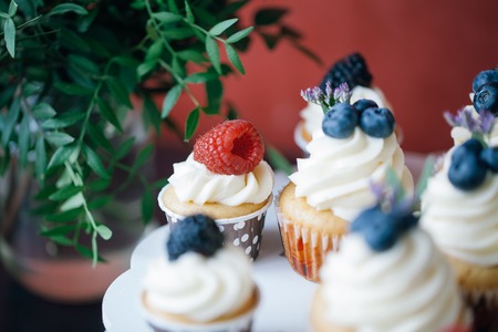 Cupcakes with berries on black table. Homemade. Macro. Indoorの写真素材