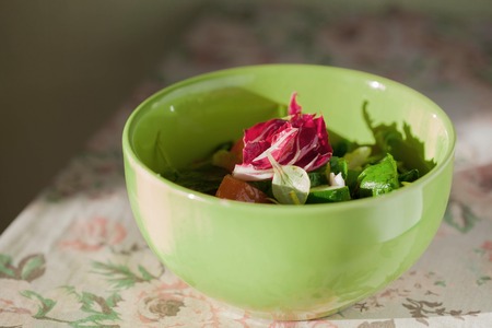Green and magenta salad in green plate. Kitchenの写真素材