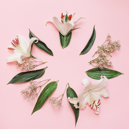 Decorative flat lay composition with flowers. Flat lay, top view on pink background. Copytextの写真素材