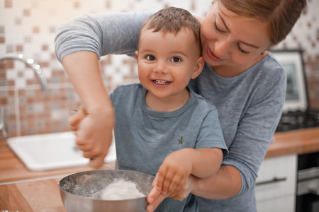 mother and son preparing pie dough in the kitchen.Indoorの写真素材