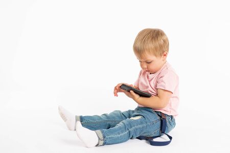 Little boy using mobile phone. Child playing on smartphone. Technology, mobile apps, children and...