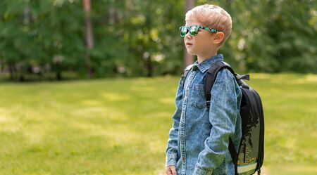portrait of cute boy with backpack. School. First grader. Outdoor