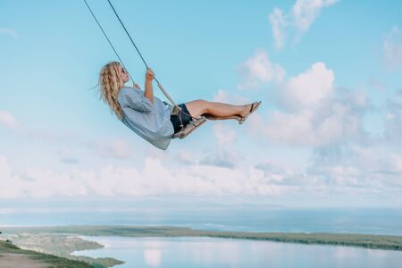 Beautiful view of young woman swing on the top of the mountain Redonda in Dominican Republic. Concept travel, vacation, tourismの写真素材