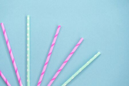 Colorful Paper coctail tubes on the blue background. Eco friendly. Zero Waste. Isolatedの写真素材